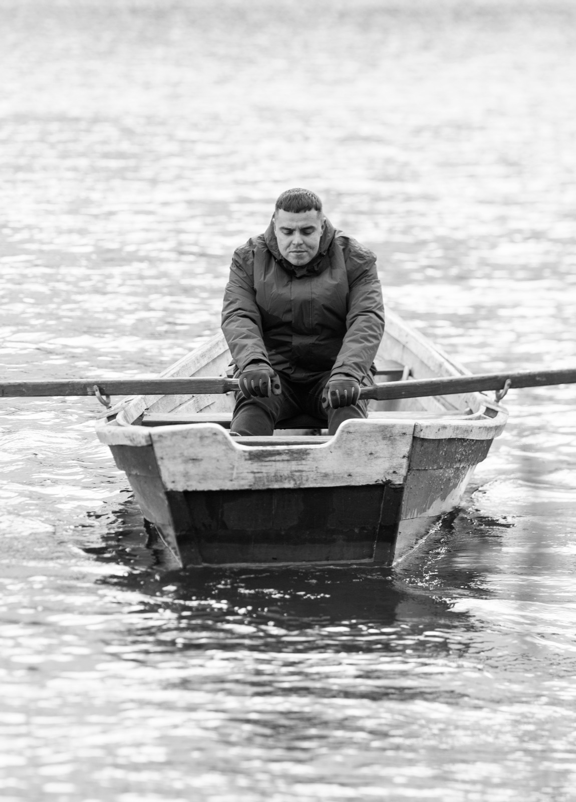 Still from the video: a man rowing a small boat