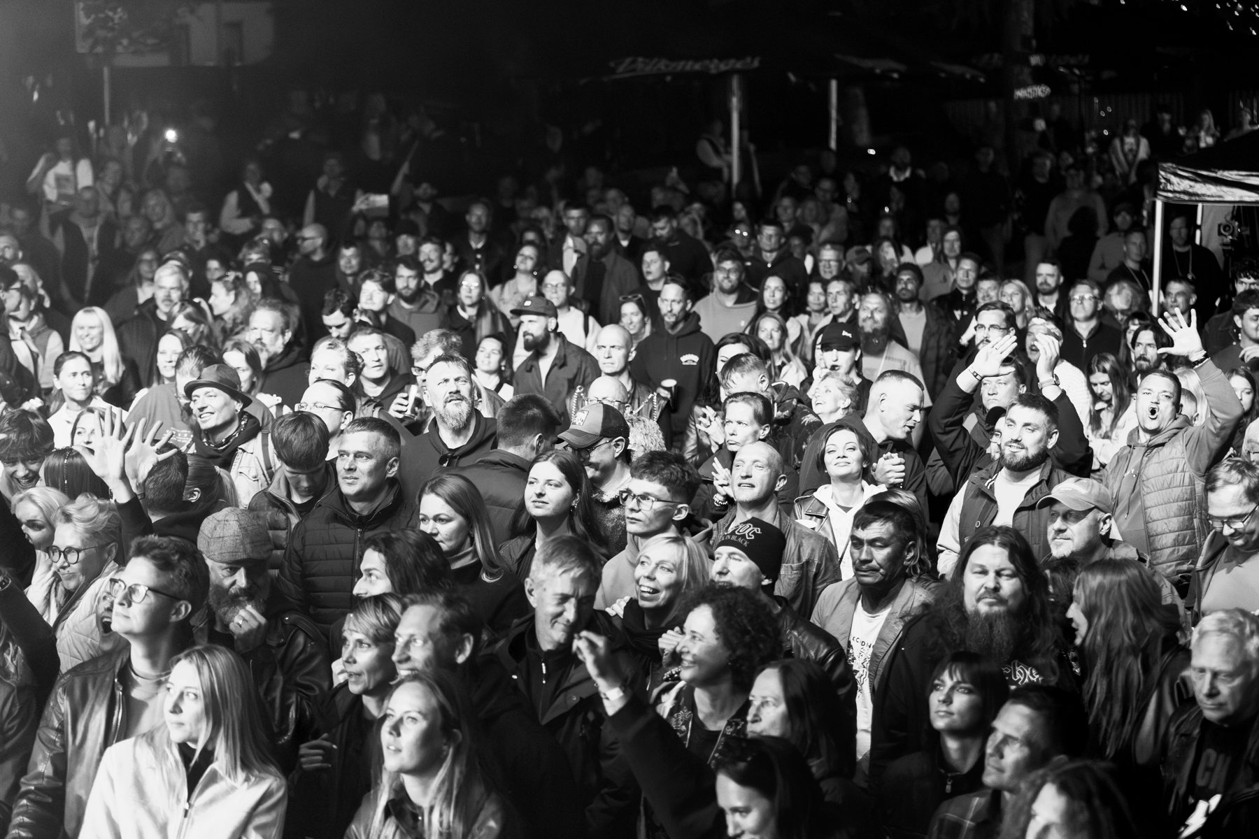 Black-and-white shot of a dense festival crowd